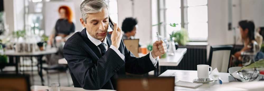 Sales employee using personal cell phone to call a customer