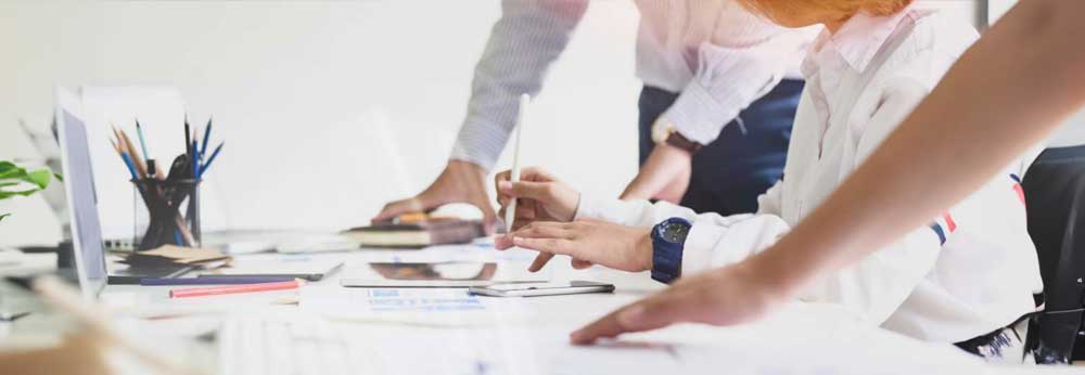 Team of employees reviewing reports