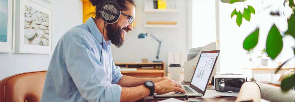 Employee with his headphones working from home